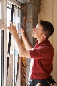 Construction Worker Installing New Windows In House