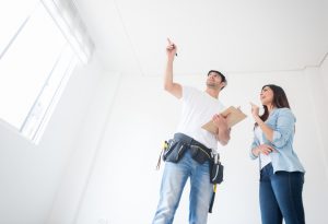 Woman talking to a construction worker about housing project